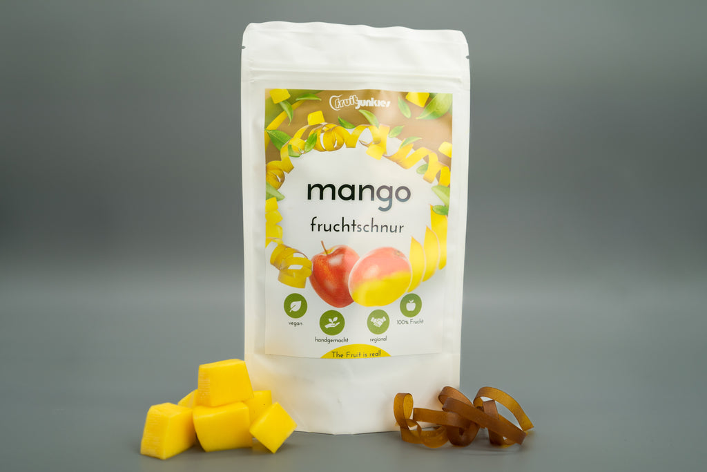 Fruchtschnur Geschmack Mango und Fruchtstücke Mango sowie einige Fruchtschlangen daneben
